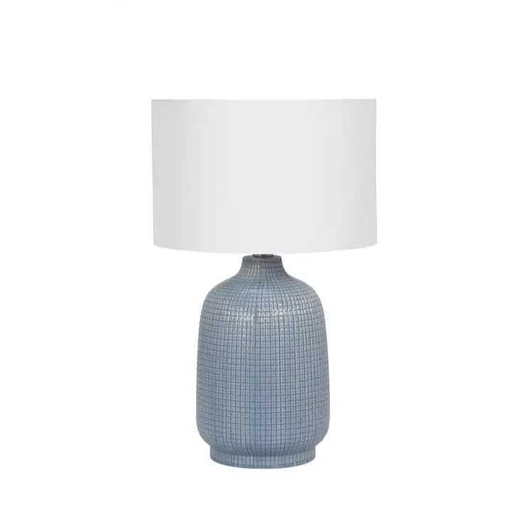 table lamp with dark sage green ceramic base and white linen shade.