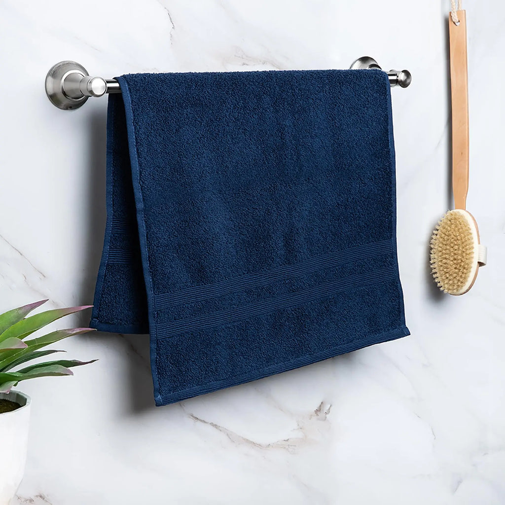Moda At Home Allure Cotton Hand Towel in indigo, hanging.
