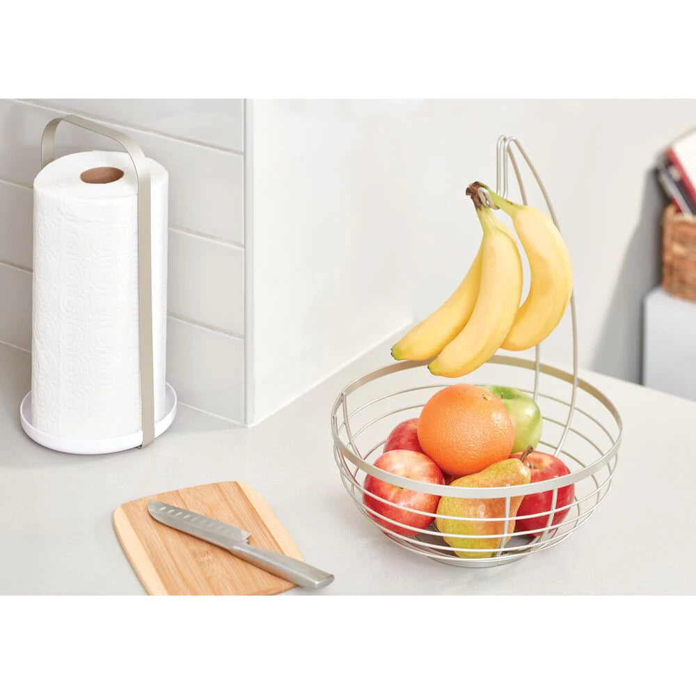 IDesign Austin Wire Fruit Basket with Hanger, in use with fruit and bananas hanging.