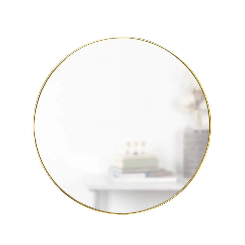 Umbra Hub Wall Mirror in brass, close up.