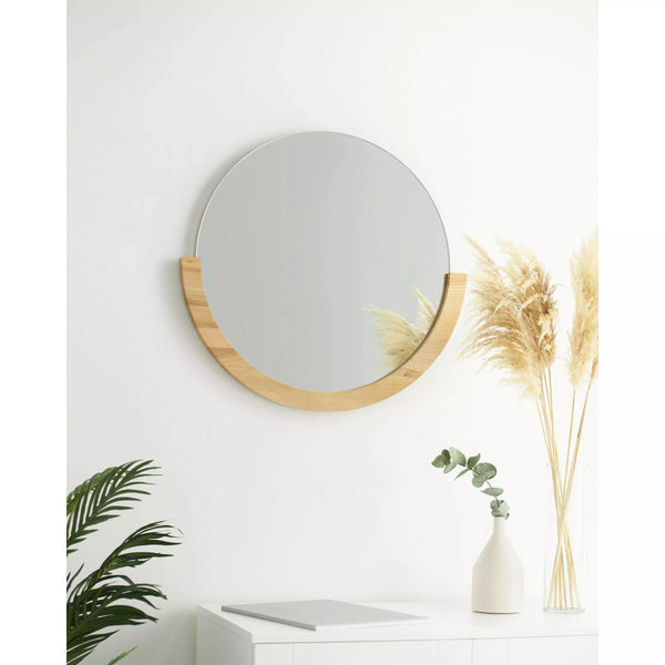 Umbra Mira Wall Mirror, light wooden half moon accent on bottom, styled above a credenza.
