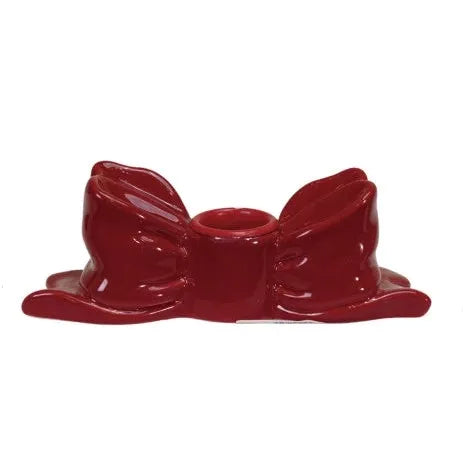 Red ceramic bow-shaped candle holder on a white background