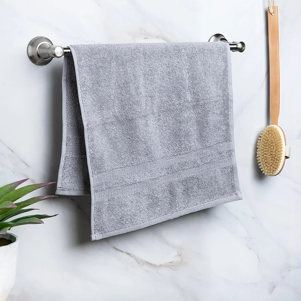 Moda At Home Allure Cotton Hand Towel, in marble grey, hanging.