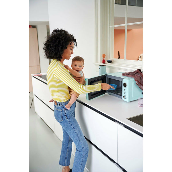 MIO Children's bowl, in blue, in use in the microwave.