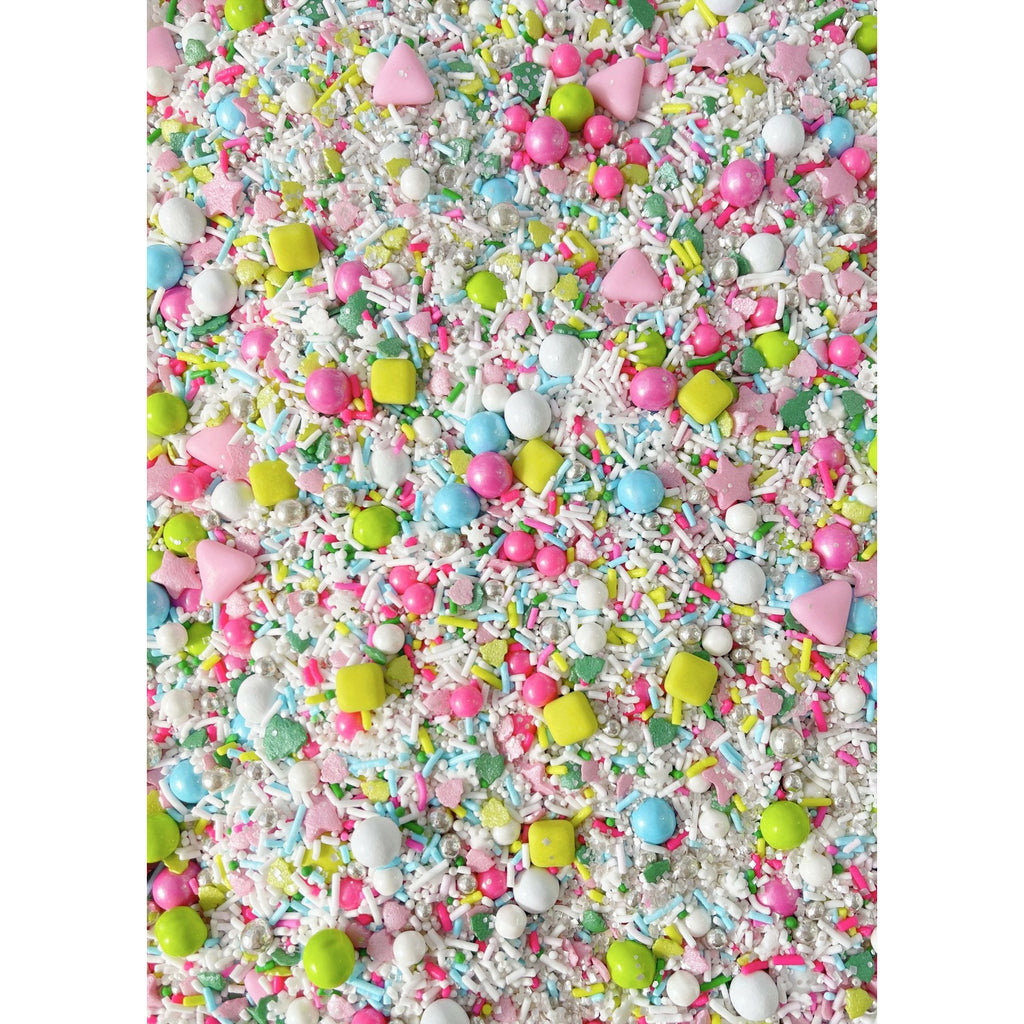 Close up of Magical Forest sprinkle medley, strands, pastel matte jumbo shapes, pink and green tree confetti in a variety of sizes, silver dragées, candy covered chocolate balls, candy beads, edible glitter, nonpareils