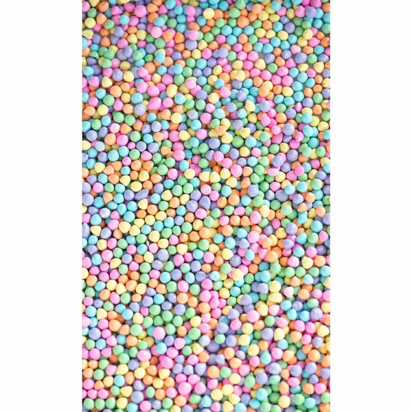 Frosted sprinkles in close up. Round bits in pastel yellow, blue, pink, purple, green, orange, and blue.