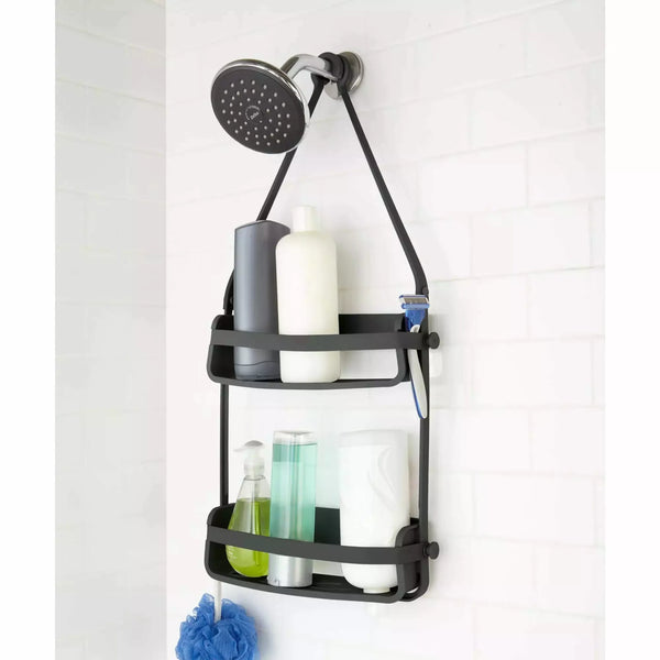 Umbra Flex Shower Caddy, in black, as lifestyle photo. Filled with shampoo and product bottles.