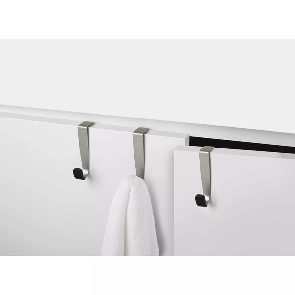 Umbra Over the Cabinet Hook in steel finish, close up, in use with towel.