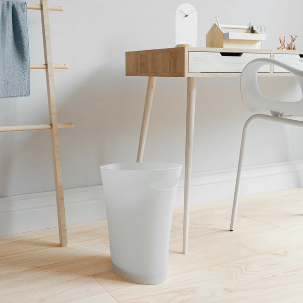 Umbra Skinny Trash Can in white next to desk.